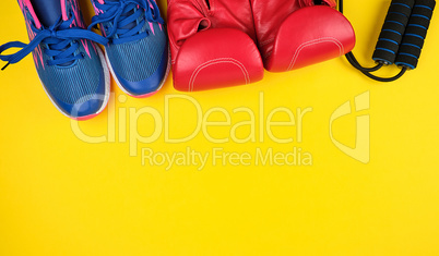 pair of blue sneakers, red leather boxing gloves
