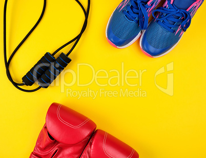 pair of blue sneakers, red leather boxing gloves