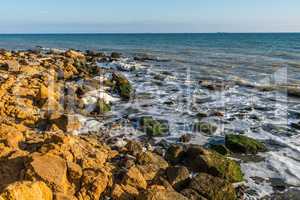 Sea foam and stones on the shore