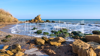 A scattering of large stones by the sea