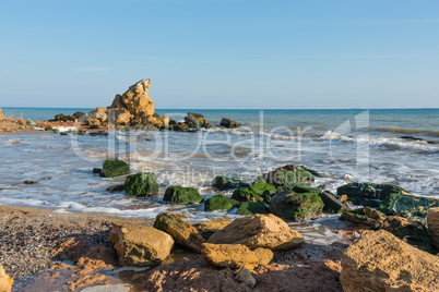 A scattering of large stones by the sea