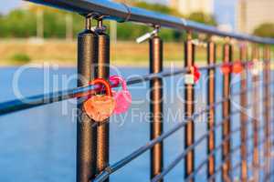 Metal locks hanging on railings.
