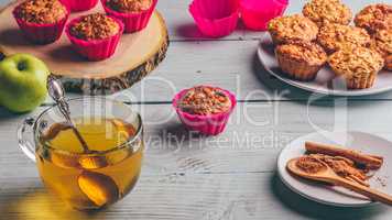 Oatmeal muffins with apple and cup of green tea.