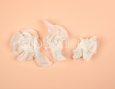 crumpled white paper napkins on a beige background