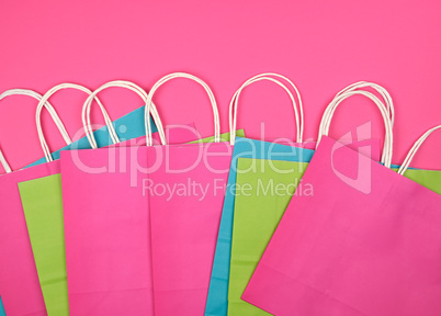 rectangular multi-colored paper shopping bags with white handles