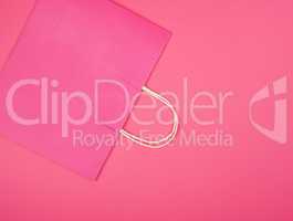 pink paper shopping bag with a handle on a white background