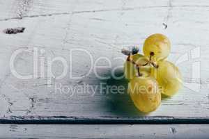Ripe green grapes on wooden background.