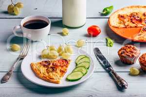 Frittata with with coffee, grapes and muffins.
