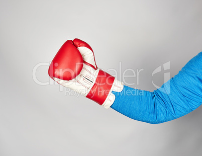 man's hand is wearing a red leather boxing glove
