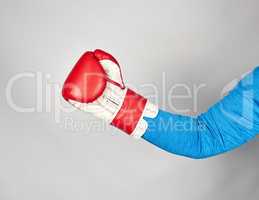 man's hand is wearing a red leather boxing glove