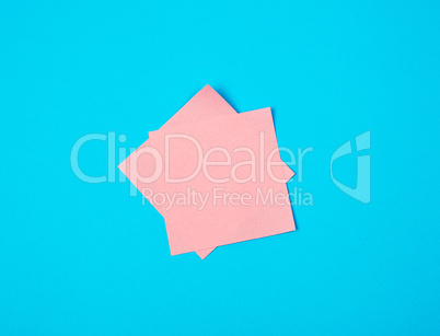 pink  empty paper square stickers on blue background