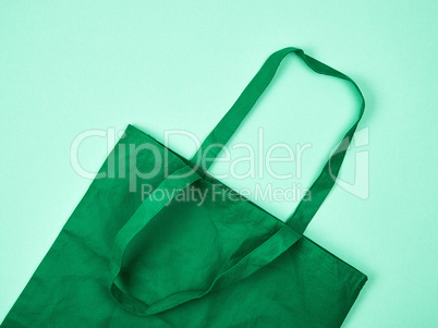 empty green ecological bag made of viscose with long handles