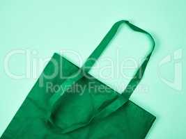 empty green ecological bag made of viscose with long handles