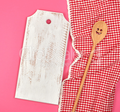 white wooden cutting board and wooden spoon