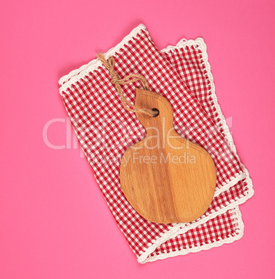 kitchen wooden cutting board and white red checkered kitchen tow