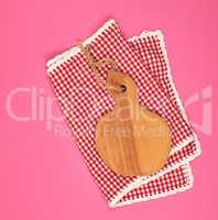 kitchen wooden cutting board and white red checkered kitchen tow