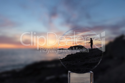 Crystal ball of Silhouette of Fisherman holding a fishing pole