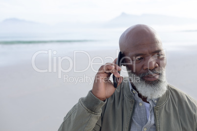 African-American man talking on the phone at the beach