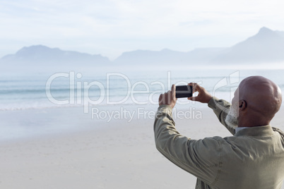 Man taking a picture at the beach