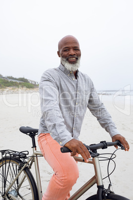 Man riding a bicycle at the beach.