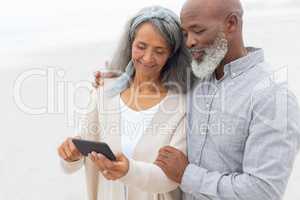 Couple looking at smartphone at the beach