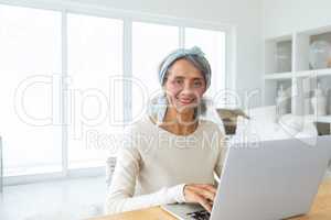 Woman using white laptop on a table.