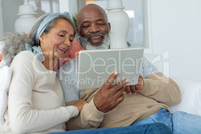 Couple using digital tablet