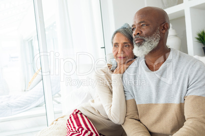 Couple sitting in a white room