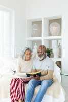 Couple reading a book while sitting