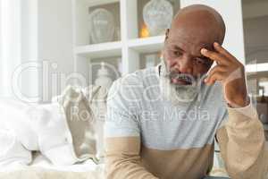 Man thinking while sitting inside a room