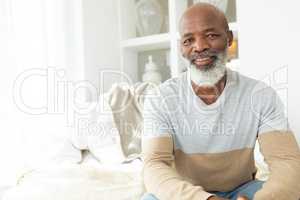 Man smiling while sitting inside a room
