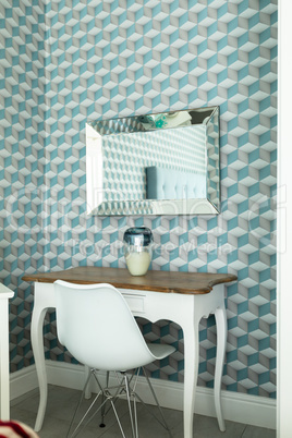 Table with chair and patterned wall