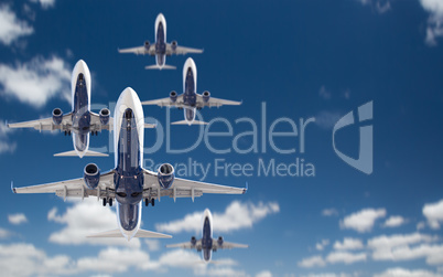 Bottom View of Several Passenger Airplanes Flying In The Blue Sk