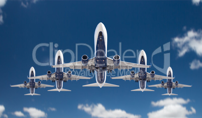 Bottom View of Five Passenger Airplanes Flying In Formation In T
