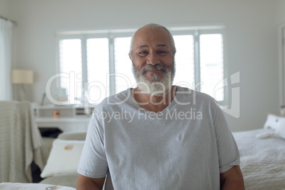 Man sitting inside white room while smiling