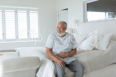 Man sitting on the bed smiling