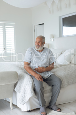 Man sitting on bed smiling