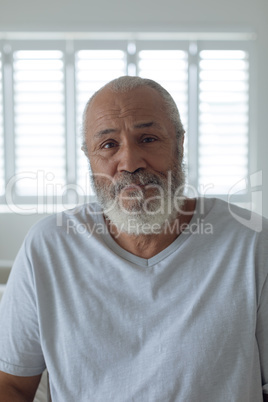 Man looking serious inside a white room