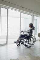 Woman on wheelchair looking outside