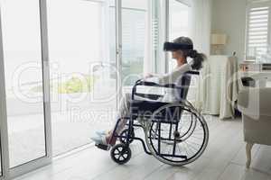Woman on wheelchair using virtual reality headset