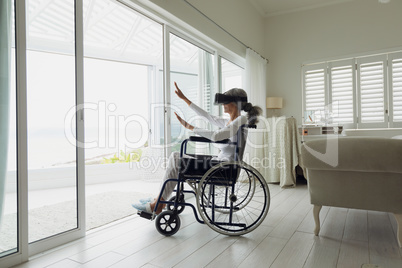 Woman on a wheelchair using virtual reality headset