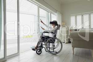 Woman on a wheelchair using virtual reality headset