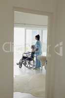 Healthcare worker and woman on wheelchair