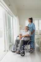 Healthcare worker and man on wheelchair