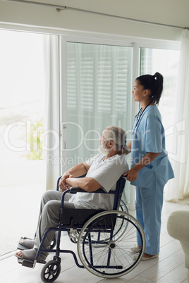 Healthcare worker with man on wheelchair