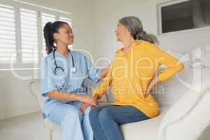 Healthcare worker and woman sitting on couch