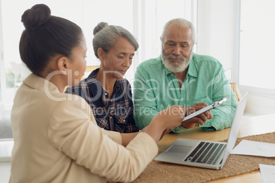 Financial adviser discussing information with a couple