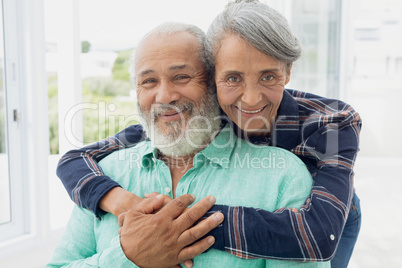 Couple smiling inside a room