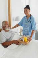 Healthcare worker talking old man in bed