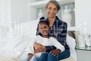 Grandmother and granddaughter smiling